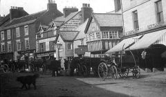 carts loading and unloading by stables in Newgate Street Morpeth 1900.JPG