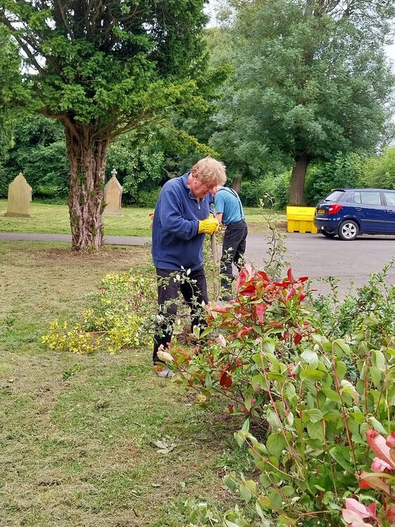 Malcolm tidying garden area.jpg